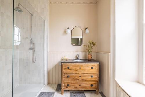 a bathroom with a sink and a shower at The Old Vicarage in Hinton Saint George