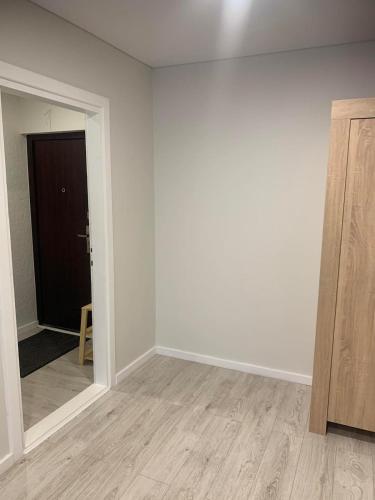 an empty room with a mirror and a door at Studio IT on Tumo in Plungė