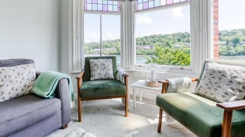a living room with two chairs and a window at Brig y Don Menai in Menai Bridge