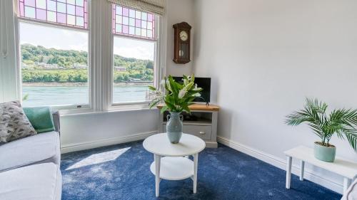 a living room with a couch and a table at Brig y Don Menai in Menai Bridge