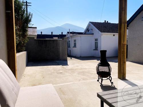 a view of a patio with a chair on a table at Central cottage Newcastle in Newcastle