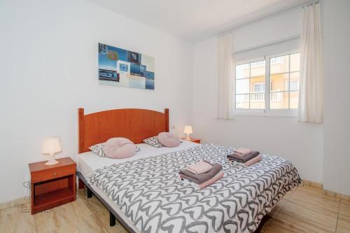 a bedroom with a bed with two pillows on it at Apartman Mar Primavera in Arona