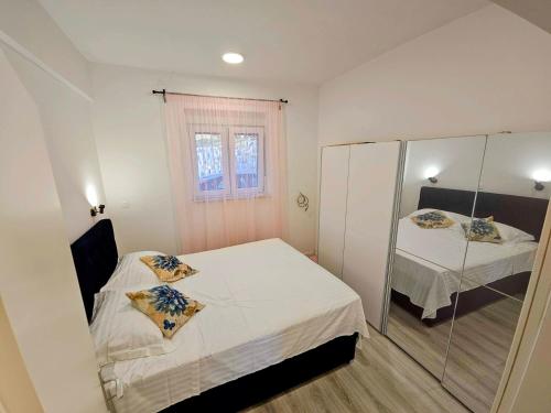 a small bedroom with two beds and a mirror at Apartment Nemo in Jesenice