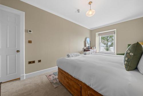 a bedroom with a large bed and a window at Cuilcheanna House - Onich, Fort William in Onich