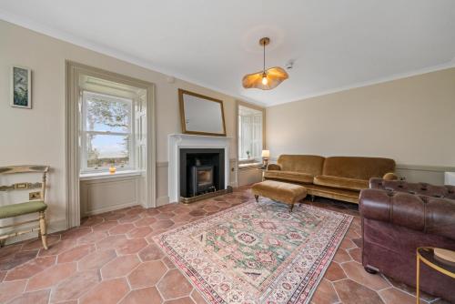 a living room with a couch and a fireplace at Cuilcheanna House - Onich, Fort William in Onich