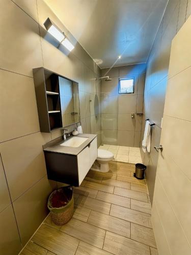 a bathroom with a sink and a toilet at Villas Na-tiva Guanacaste in Plazuela