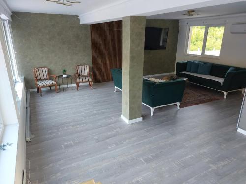 a living room with a couch and chairs at Halal Kuca sa bazenom u Mostaru in Mostar