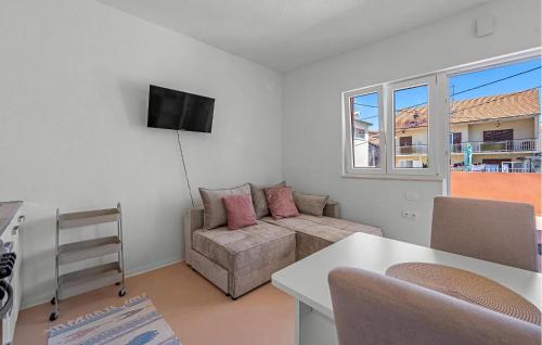 a living room with a couch and a table at 1 Bedroom Lovely Apartment In Brodarica in Brodarica