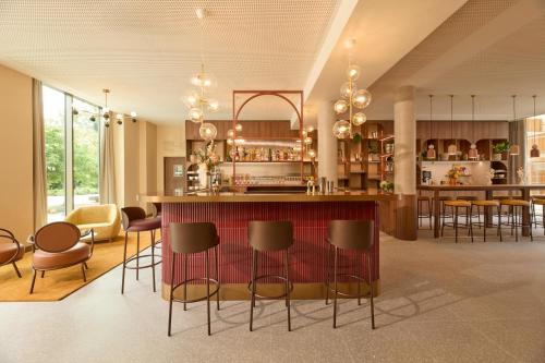 a kitchen with a bar and some chairs at OKKO Hotels Troyes Centre in Troyes