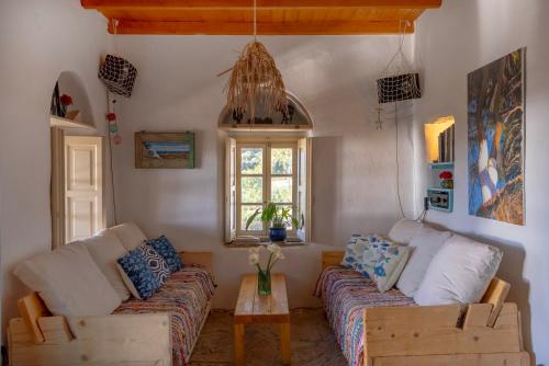 a living room with a couch and a table at Annas Katikia in Drymonas