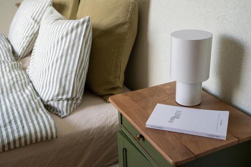 a lamp on a table next to a bed at Maison Veyronne ferme rénovée avec piscine in Dizy