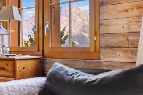 a bedroom with a view of a mountain through windows at Marcotte - 8 pers - belle vue in Nendaz