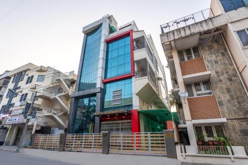 a building in the middle of some buildings at 4 BHK Luxury Penthouse- Sliceinn Velvet, Wilson Garden, Bangalore in Bengaluru