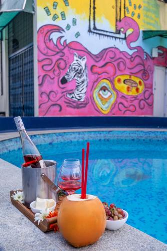 a tray of food and drink next to a swimming pool at 4 BHK Luxury Penthouse- Sliceinn Velvet, Wilson Garden, Bangalore in Bengaluru