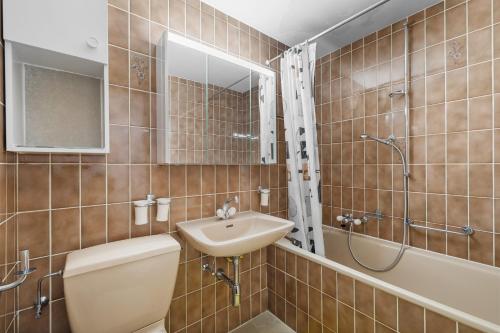 Un baño con lavabo, inodoro y ducha. en Dents-Rousses D4 - 4 pers - ski In&Out, en Siviez