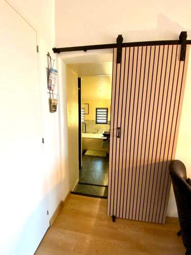 a door leading to a room with a bathroom at Maison romantique avec Balnéo Duo in La Bernerie-en-Retz