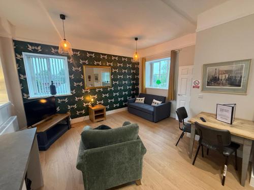 a living room with a couch and a table at Church Street Apartments in Kidderminster
