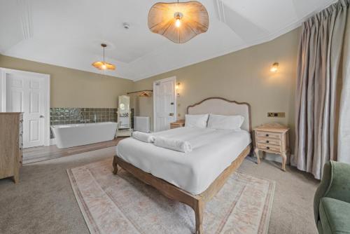 a bedroom with a large bed and a bath tub at Cuilcheanna House - Onich, Fort William in Onich