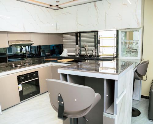 a kitchen with a counter and a chair in it at Heaven apartments in Gisenyi