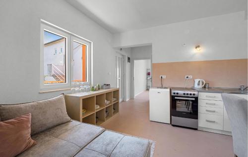 a kitchen with a couch and a stove in a room at Stunning Apartment In Brodarica in Brodarica