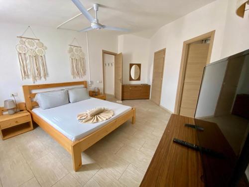 a bedroom with a bed with a towel on it at Djadsal Moradias - by Bobbywashere in Santa Maria