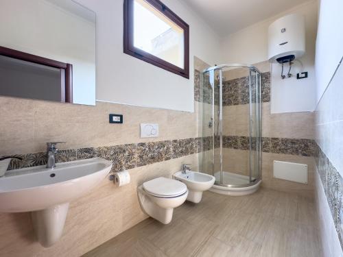 a bathroom with a sink and a toilet and a shower at Casa Helios in Sassari