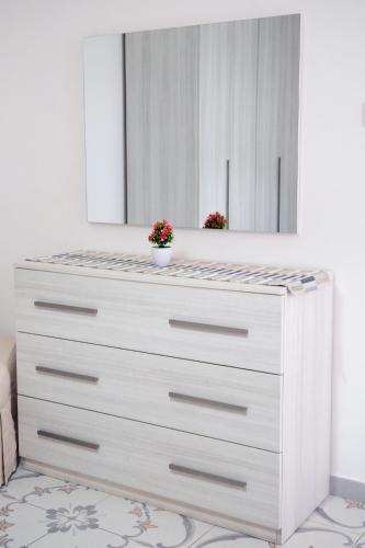 a dresser with a mirror on top of it at Pharus Miseni Suites and rooms in Bacoli
