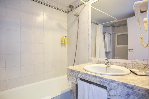a bathroom with a sink and a tub at BQ Sarah -Adults Only in Can Picafort