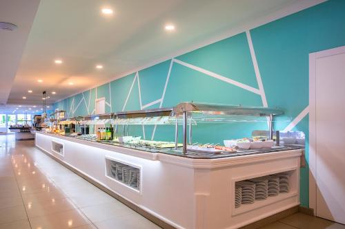 a buffet line with food on display in a restaurant at BQ Sarah -Adults Only in Can Picafort