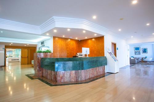 a lobby with a reception desk in a building at BQ Sarah -Adults Only in Can Picafort