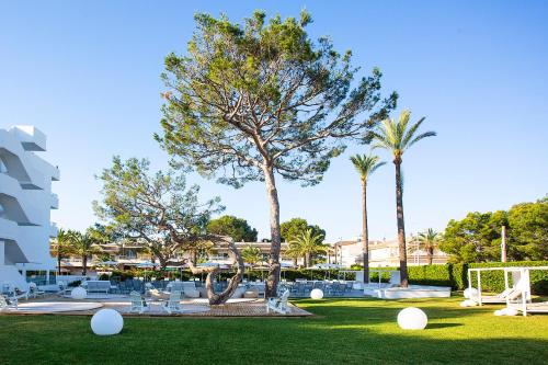 a park with palm trees and a soccer field at BQ Sarah -Adults Only in Can Picafort