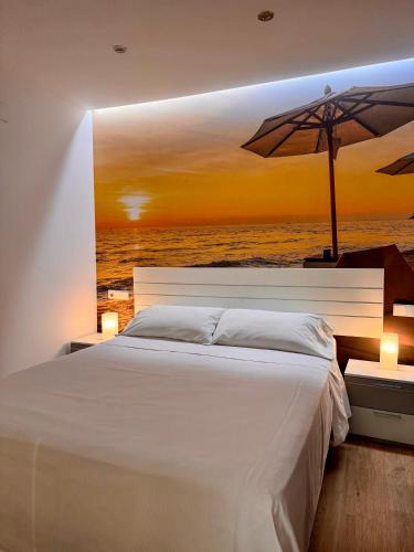 a bedroom with a bed with an umbrella at Color Suites Alicante in Alicante