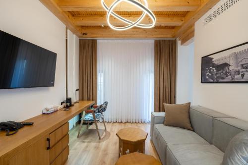 a living room with a couch and a desk at Sarhad Hotel in Bukhara