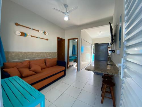 a living room with a couch and a table at Chalés Céu e Mar Ubatuba in Ubatuba