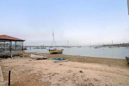 a group of boats on the shore of a body of water at Villa Alvor Rooftop in Alvor