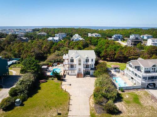 an aerial view of a house and a pool at Whalehead Adventure With Ocean Views Pool Spa in Corolla