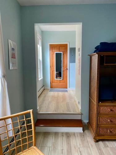 a hallway with a wooden door in a room at Hasty House Studio in Auburn