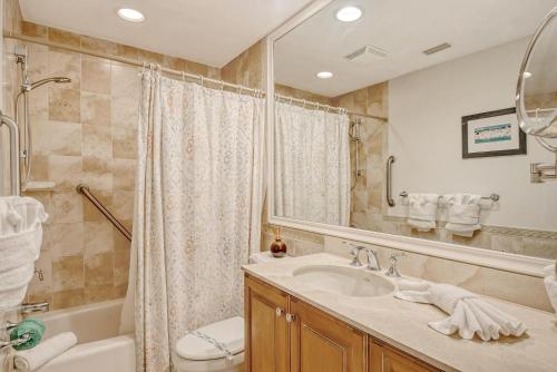 a bathroom with a sink and a tub and a toilet at Crescent Royale Condominiums 205 in Siesta Key