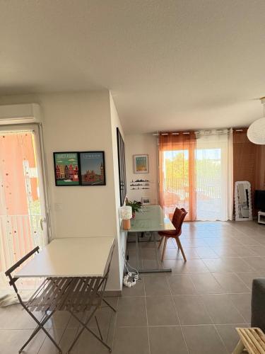 un salon avec une table et une salle à manger dans l'établissement T2 Air conditioning Terrace & Parking near Montpellier, à Juvignac
