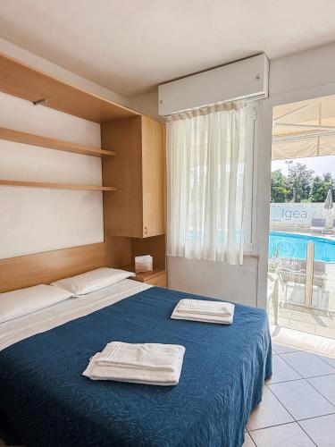 a bedroom with a bed with two towels on it at Hotel Bella Igea in Bellaria-Igea Marina