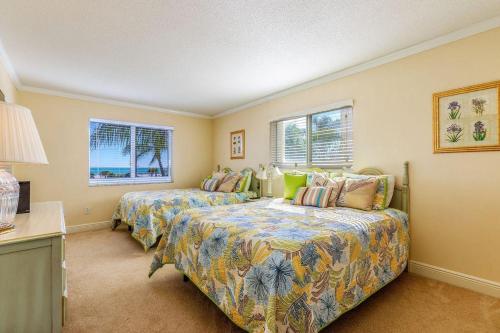 a bedroom with two beds and two windows at Crescent Royale Condominiums 301 in Siesta Key