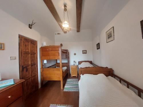 a bedroom with two beds and a dresser in it at Siske malom in Balatonfüred