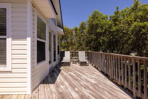 a porch of a house with two chairs on it at Oceanside retreat with pool & spa June Weeks Open in Sanderling