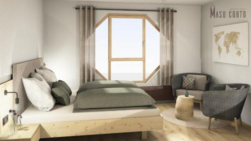 a bedroom with a bed with a window and a chair at Aparthotel Maso Corto in Maso Corto