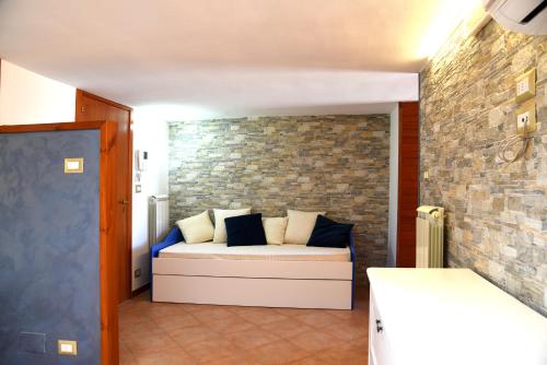 a couch in a room with a brick wall at Nereidi in Lecce