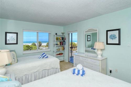 a bedroom with two beds and a view of the ocean at Crescent Royale 306 in Siesta Key