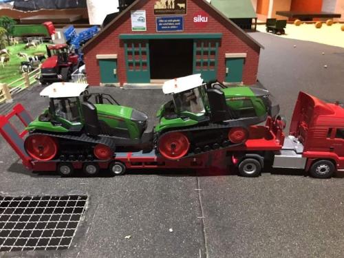 a toy tractor and a truck in front of a building at Large Apartment In The Vacation Center Whirlpool in Diemtigen