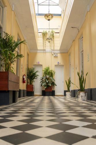 an empty hallway with potted plants in a building at Hospedaje Santa Rosa- Centro Histórico in Lima