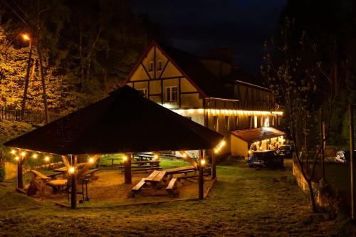 a building with a gazebo at night with lights at Pensjonat Sokolec in Sokolec