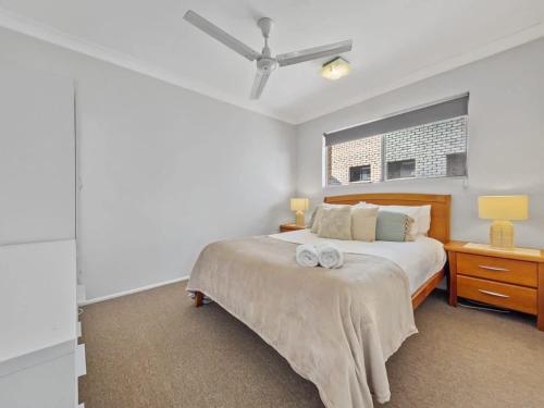 a bedroom with a bed and a ceiling fan at Waterfront Serenity - Steps from Mooloolaba Beach in Mooloolaba
